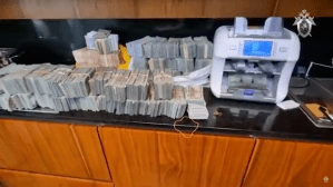 Stacks of cash and a money counting machine.